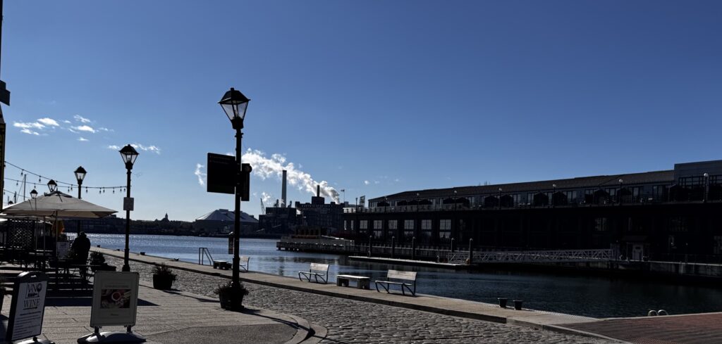 Thames Street waterfront view toward Harbor East, emphasizing maritime weather conditions that often lead to denied homeowners insurance claims in Baltimore.